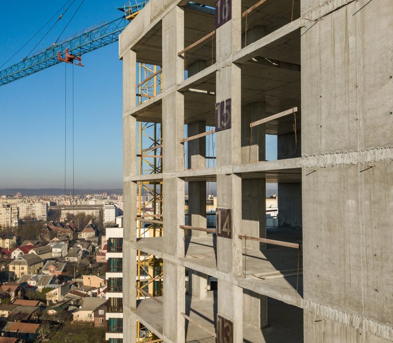 Aerial view of concrete frame of tall apartment building under construction in a city
