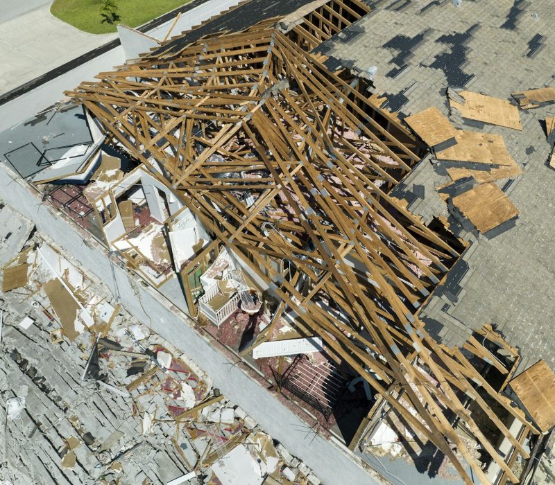 Damaged house roof and walls after hurricane Ian in Florida. Consequences of natural disaster