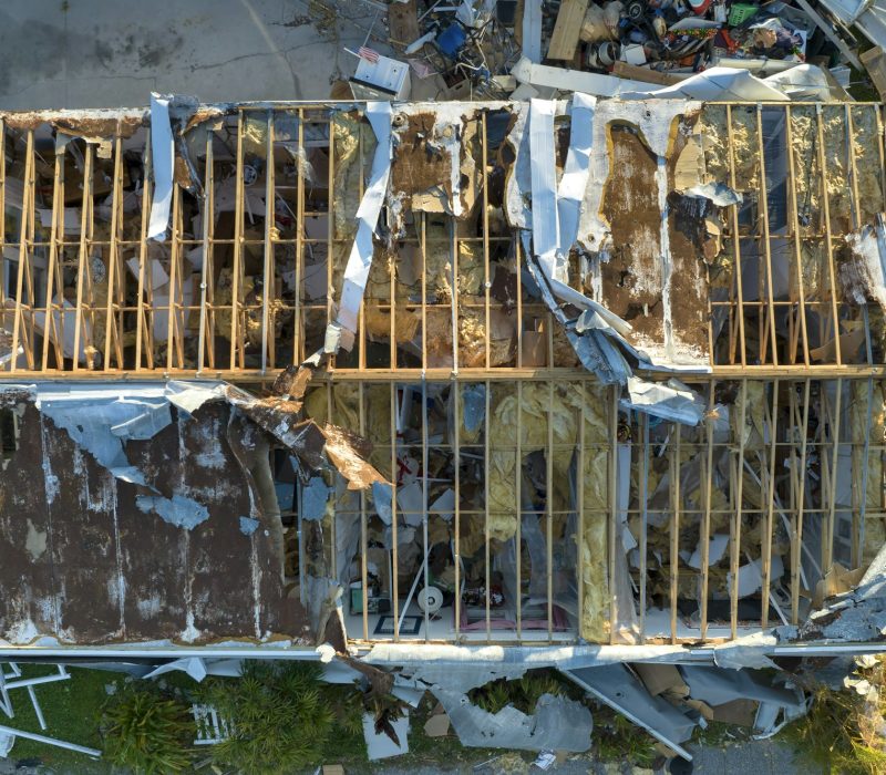 Severely damaged houses after hurricane Ian in Florida mobile home residential area.